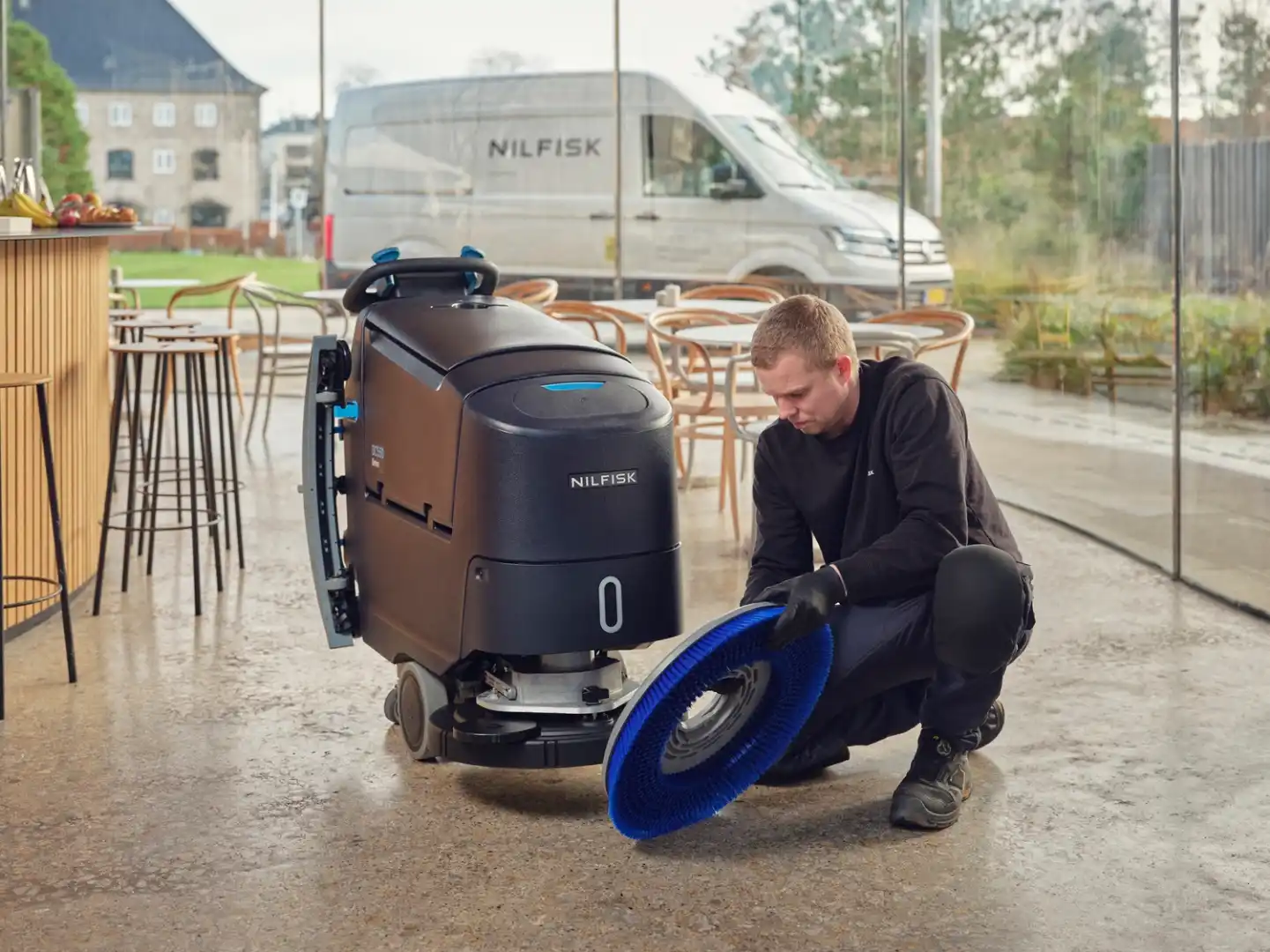 Técnico de mantenimiento especialista SAT reparando máquina fregadora Nilfisk